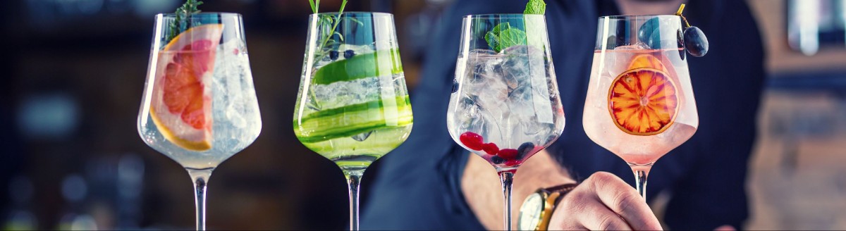 Fyra glas med färgglada drinkar.